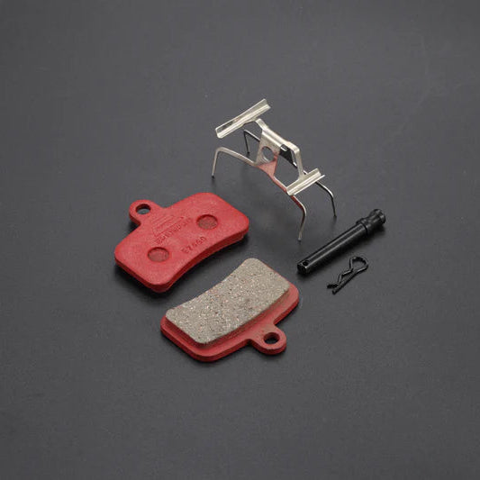 Brake pads and components on a dark gray background
