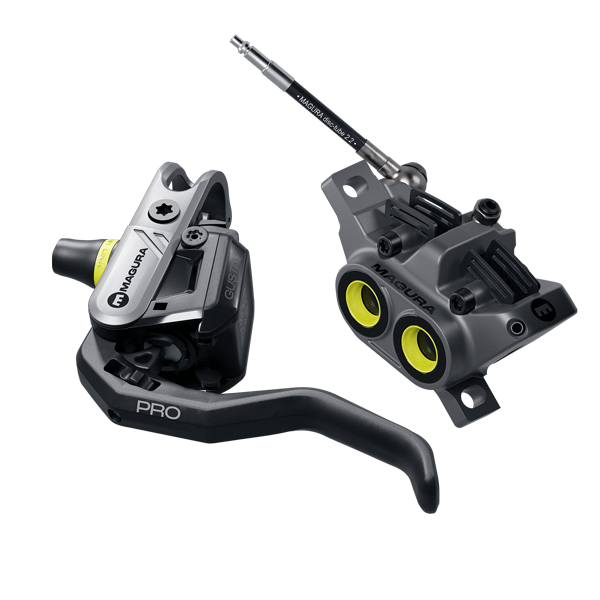 Gustav PRO E-MTB brake system combo showcasing lever, caliper, rotor, and hose with orange MC inlay and caliper rings.