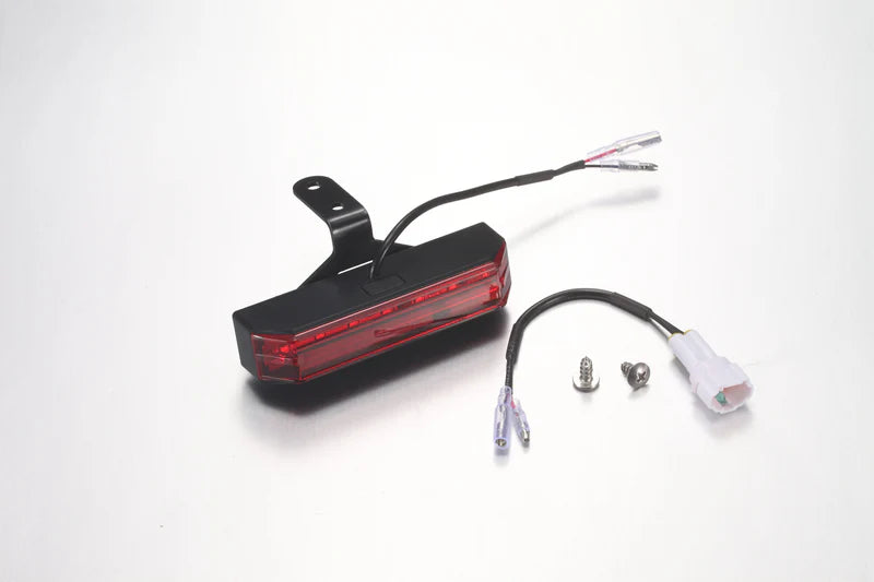 Red LED light with wiring on a white background