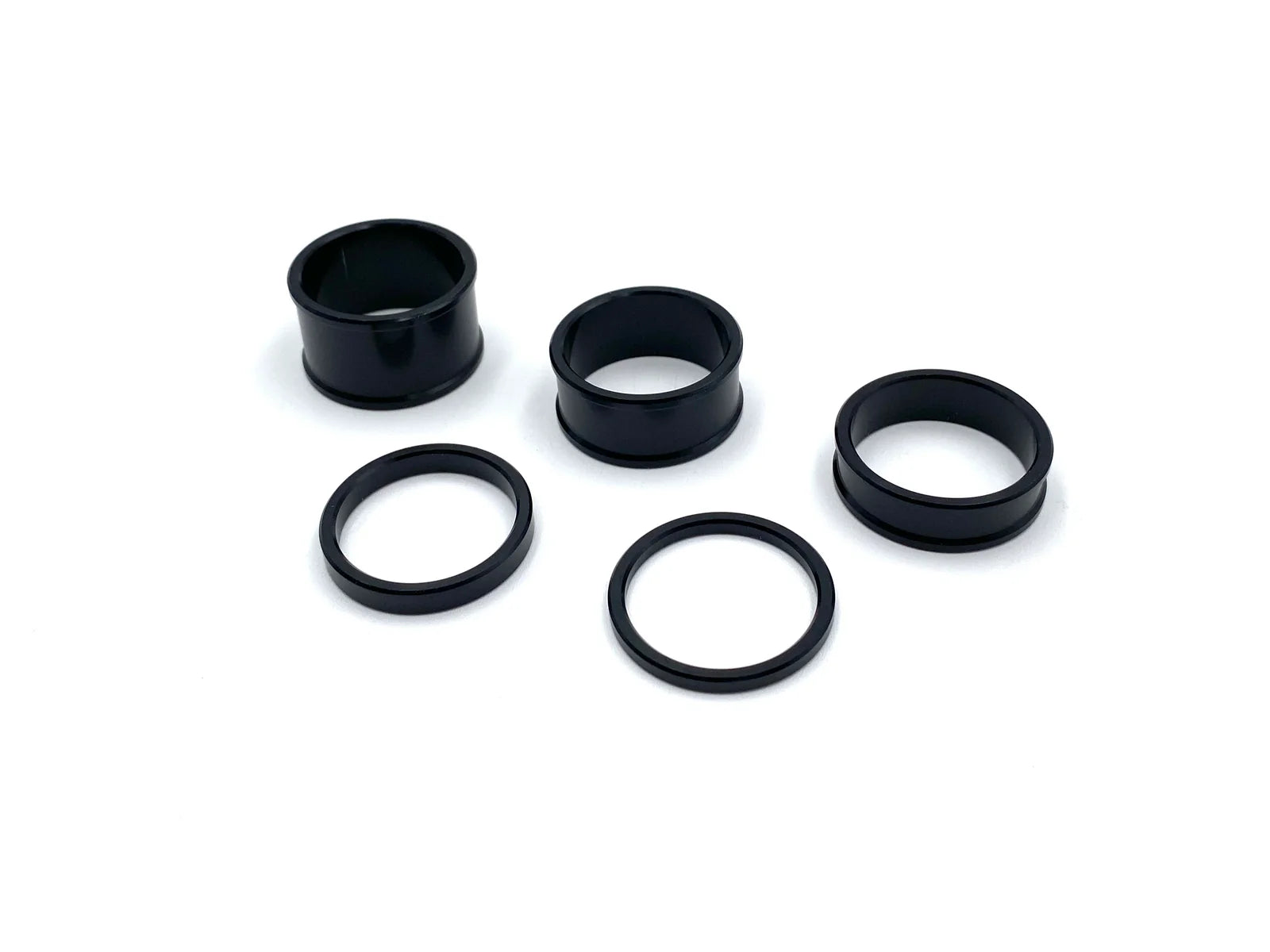 Set of black spacer rings on a white background